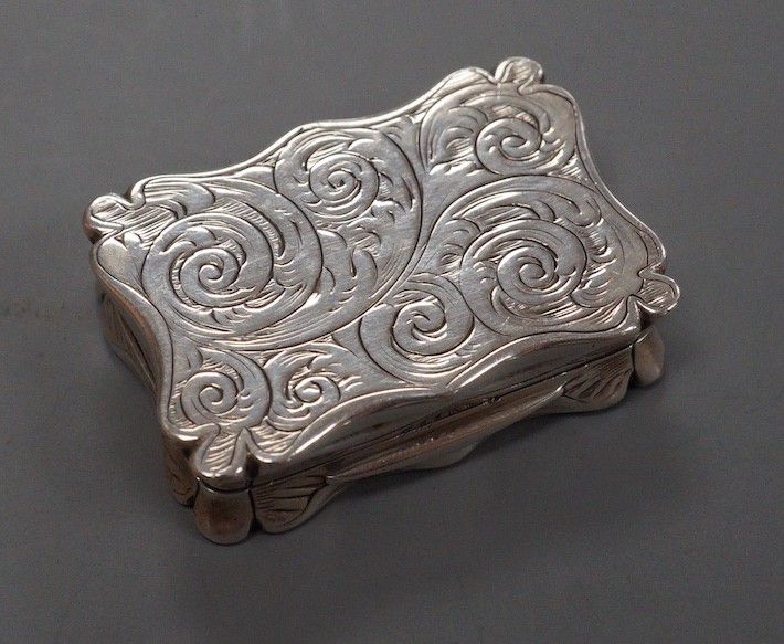 A Victorian engraved silver shaped rectangular snuff box, Edward Smith, London, 1855, 37mm (bale hole? on one side).
